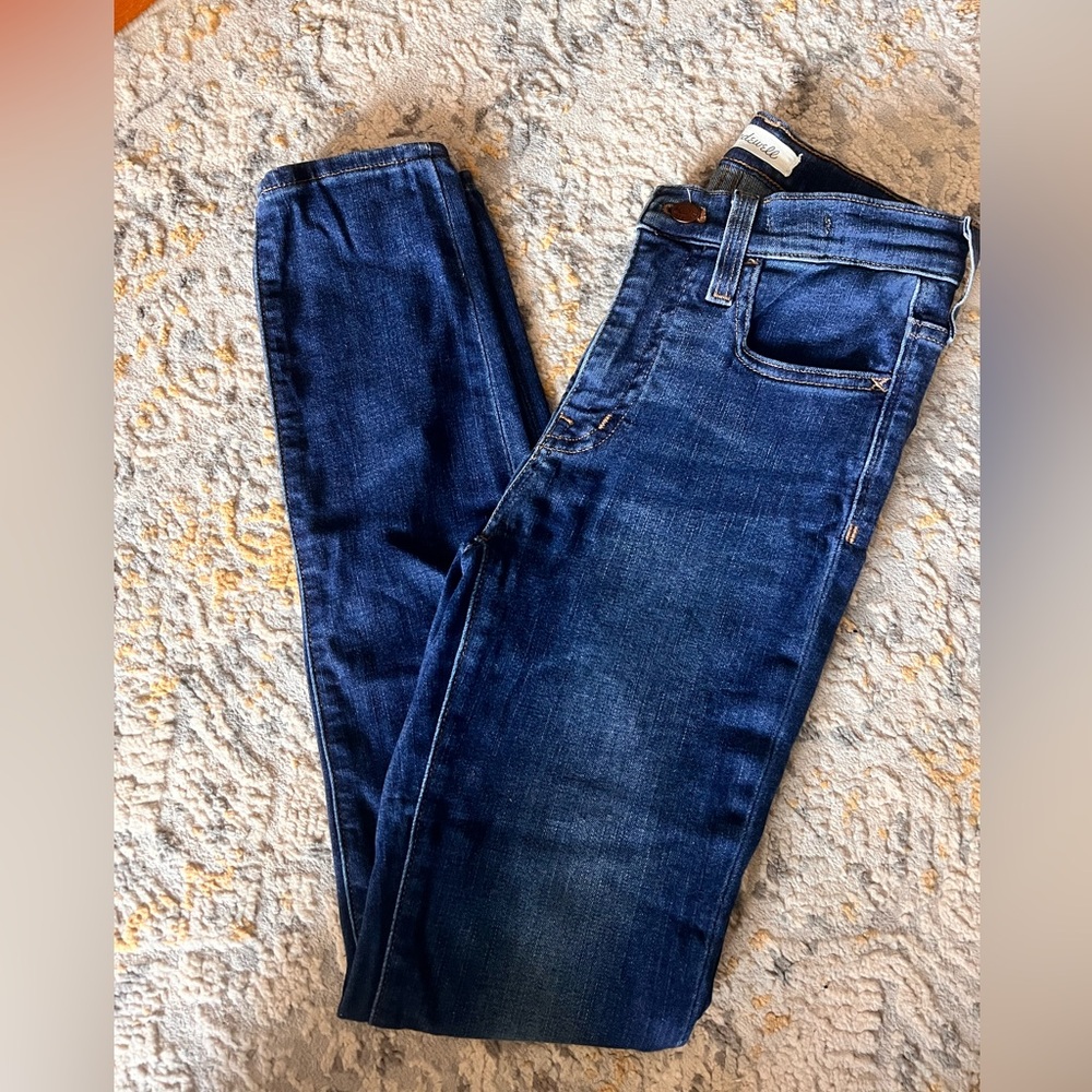 Madewell women’s mid-rise skinny dark blue jeans.